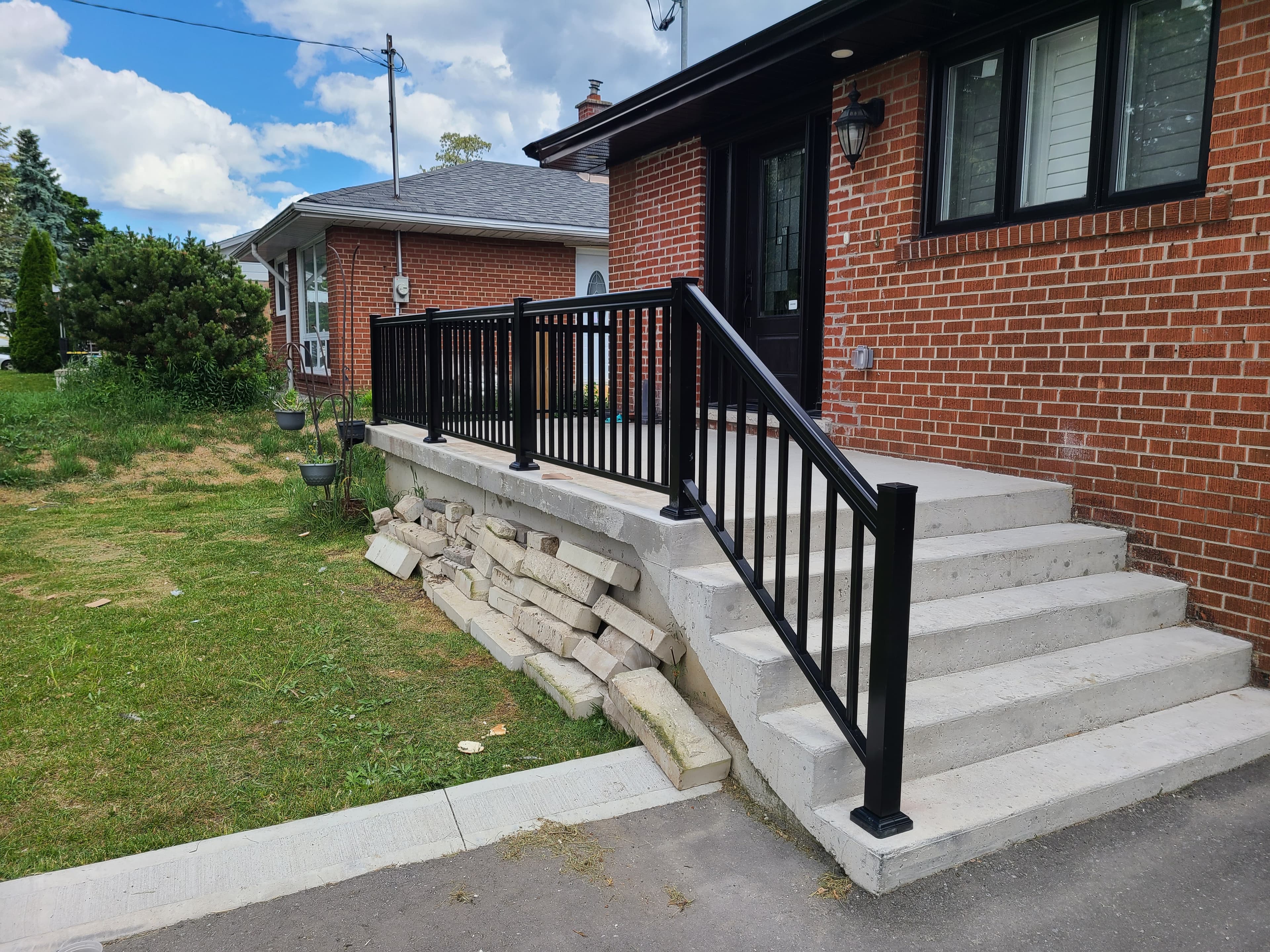 Black aluminum picket railing on front steps