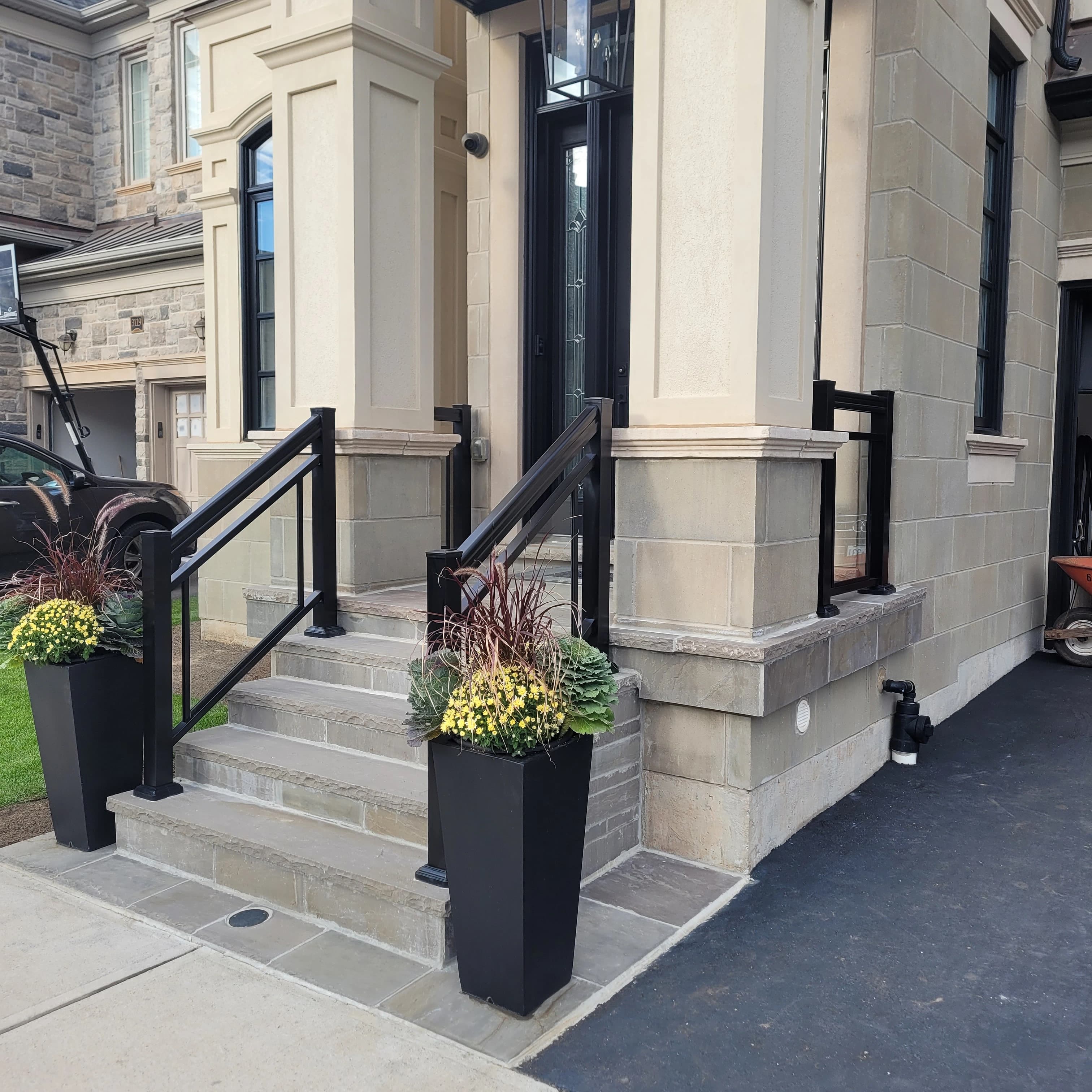 Clear glass railing with double bar on stone entry