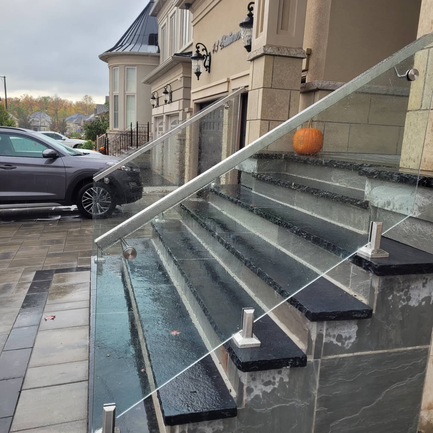 Frameless glass railing on brick stairs